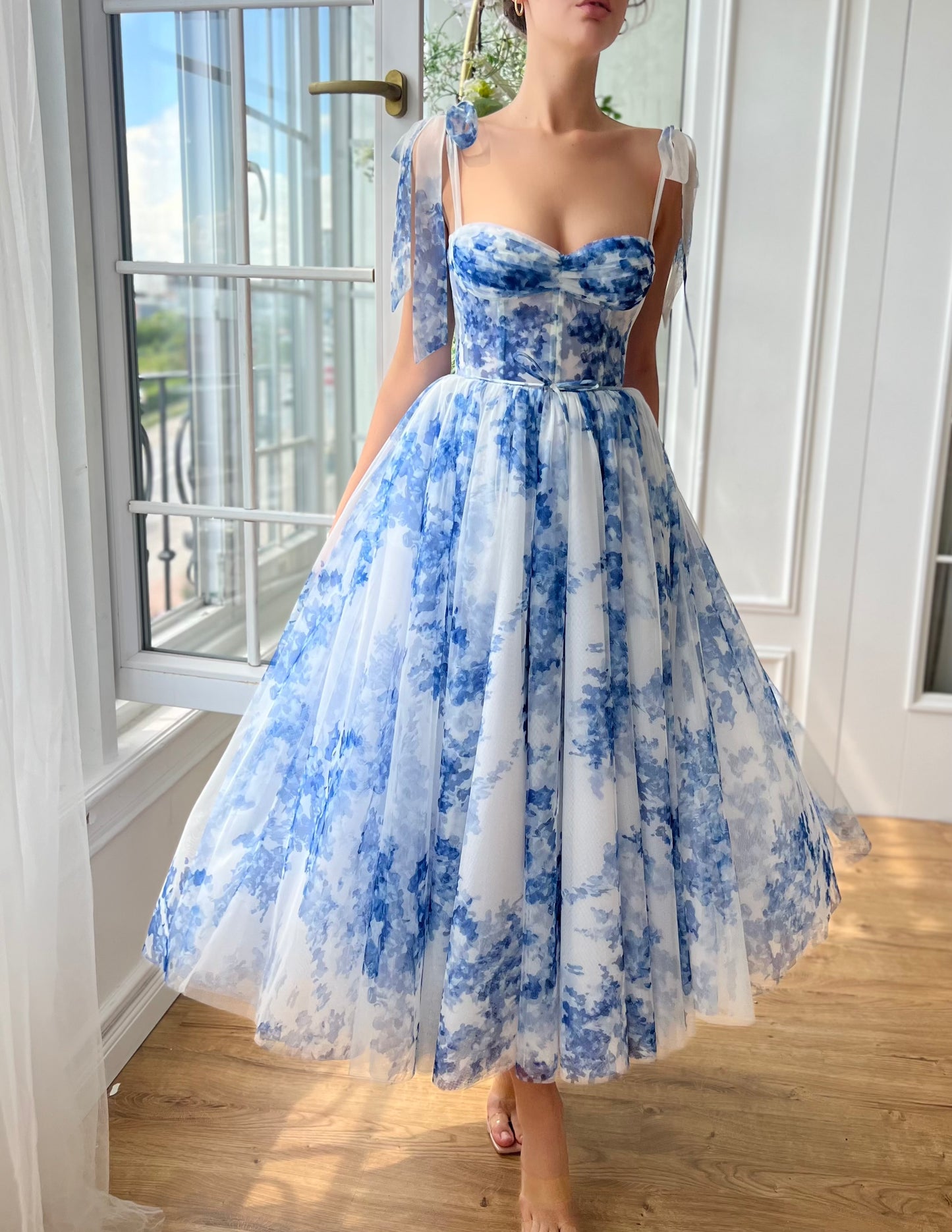 Blue midi dress with floral print and bow straps