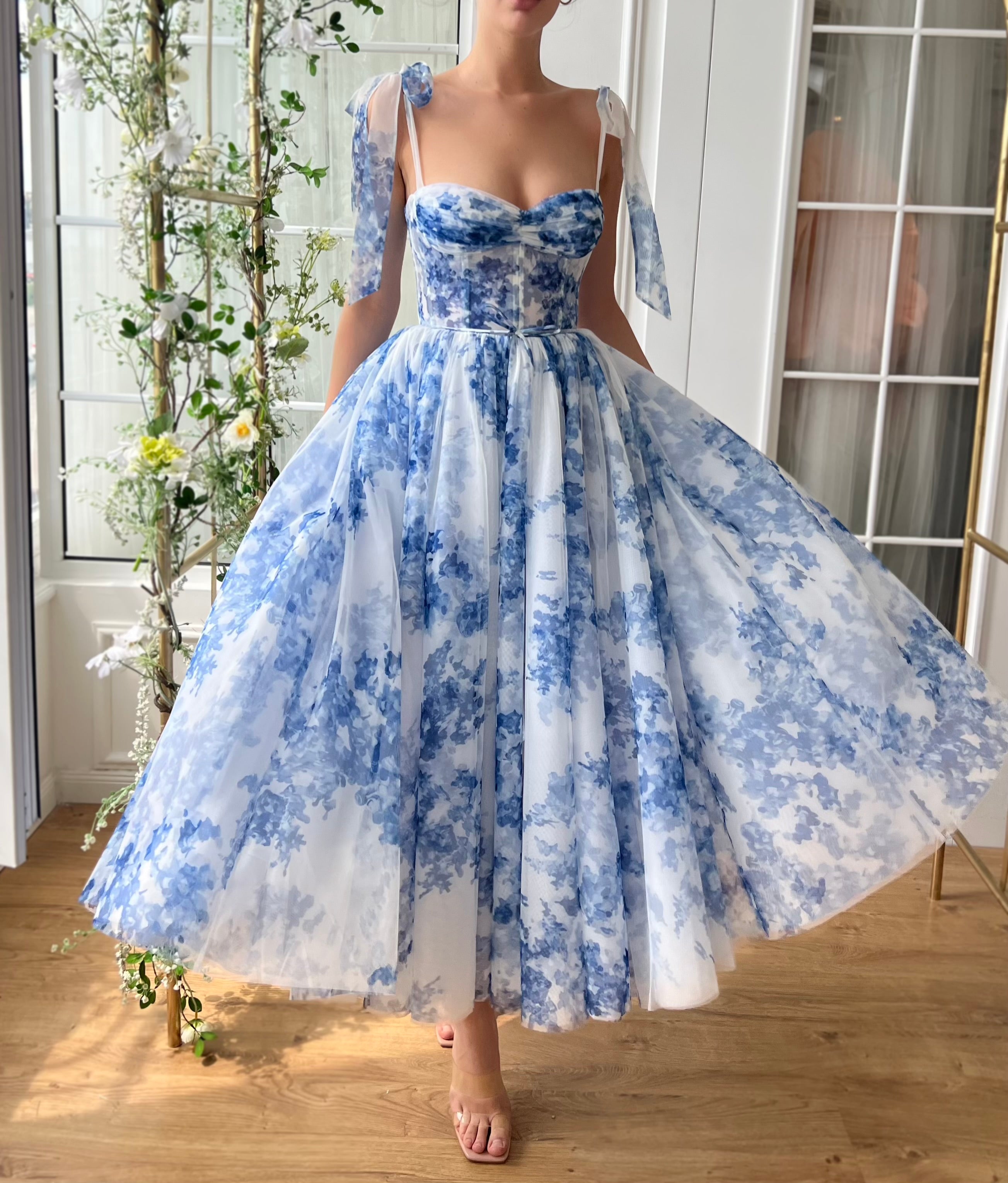 Blue midi dress with floral print and bow straps