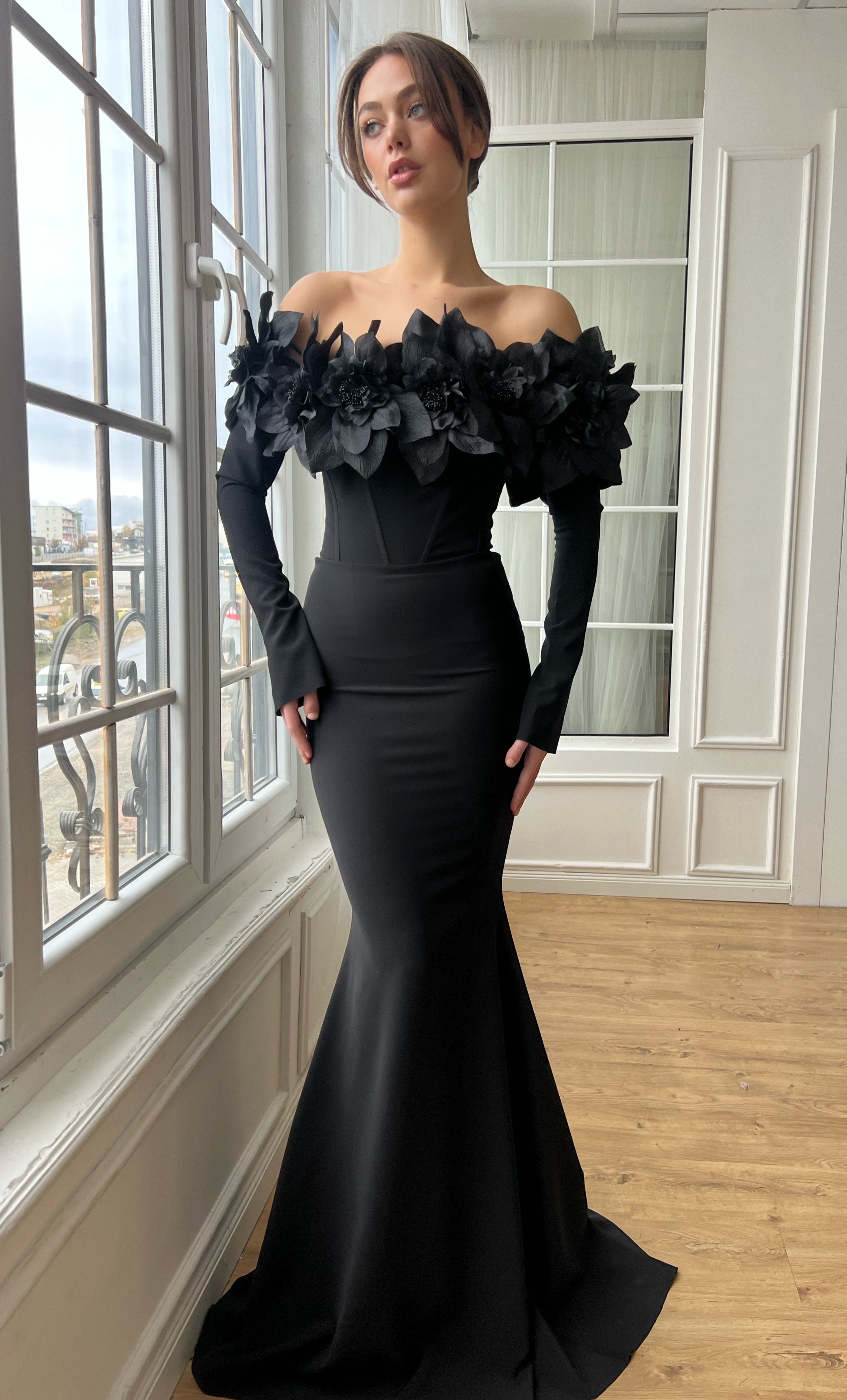 Black mermaid dress with long off the shoulder sleeves and embroidery