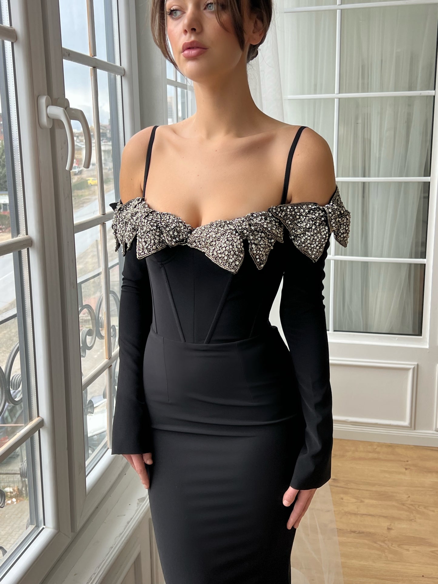 Black mermaid dress with long off the shoulder sleeves, spaghetti straps and embroidery