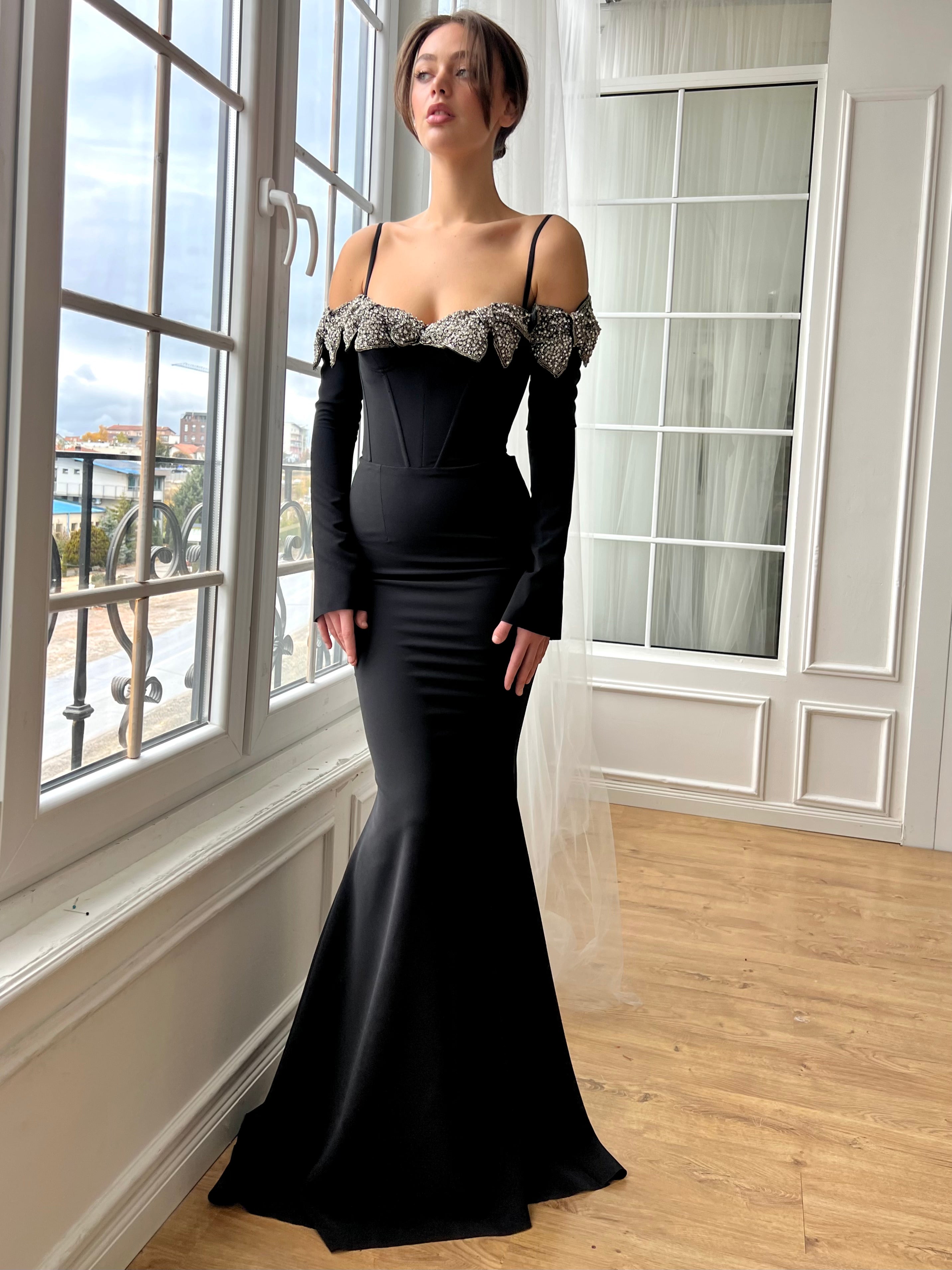 Black mermaid dress with long off the shoulder sleeves, spaghetti straps and embroidery