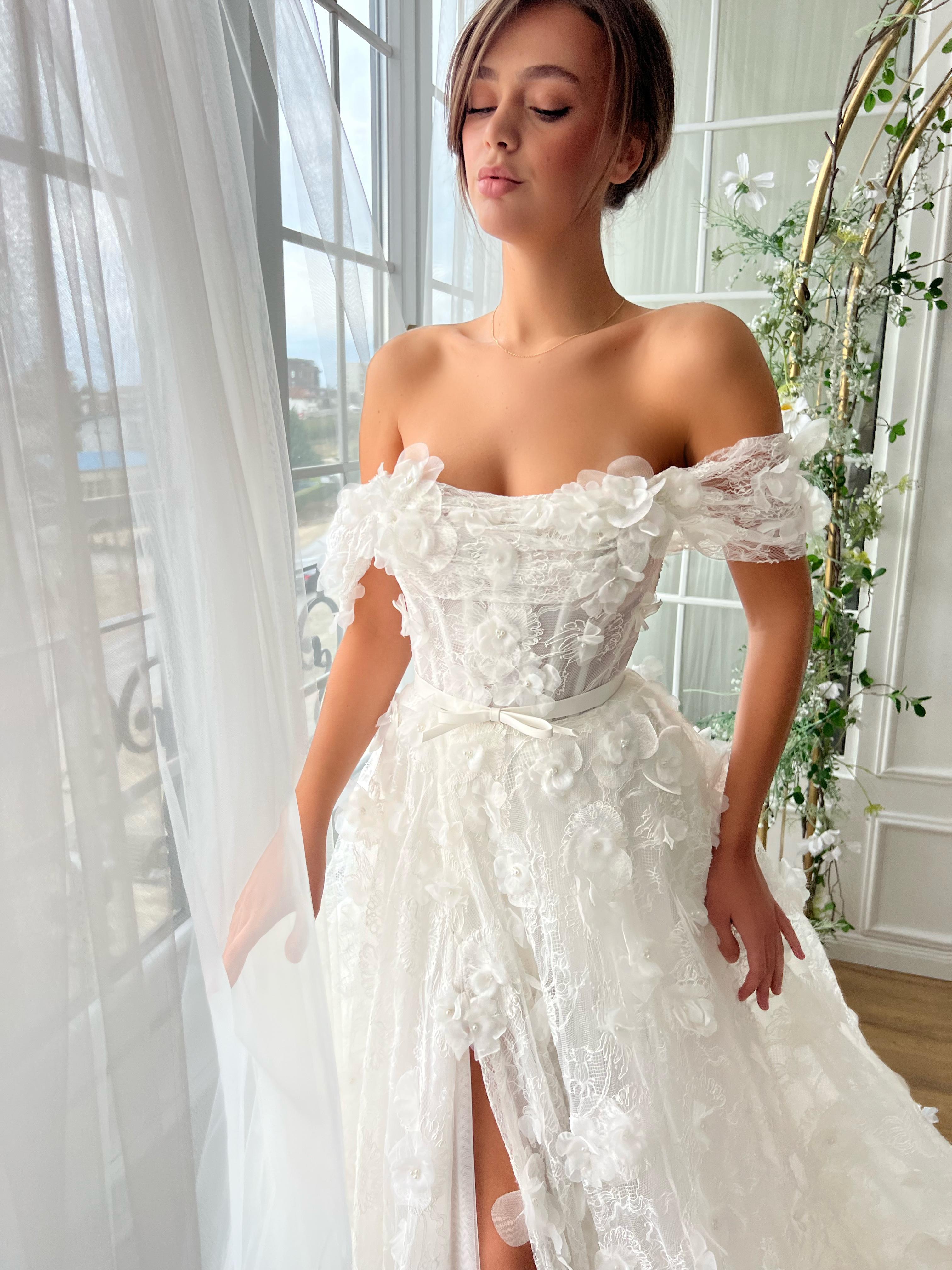 White bridal A-Line gown with off the shoulder sleeves and embroidery