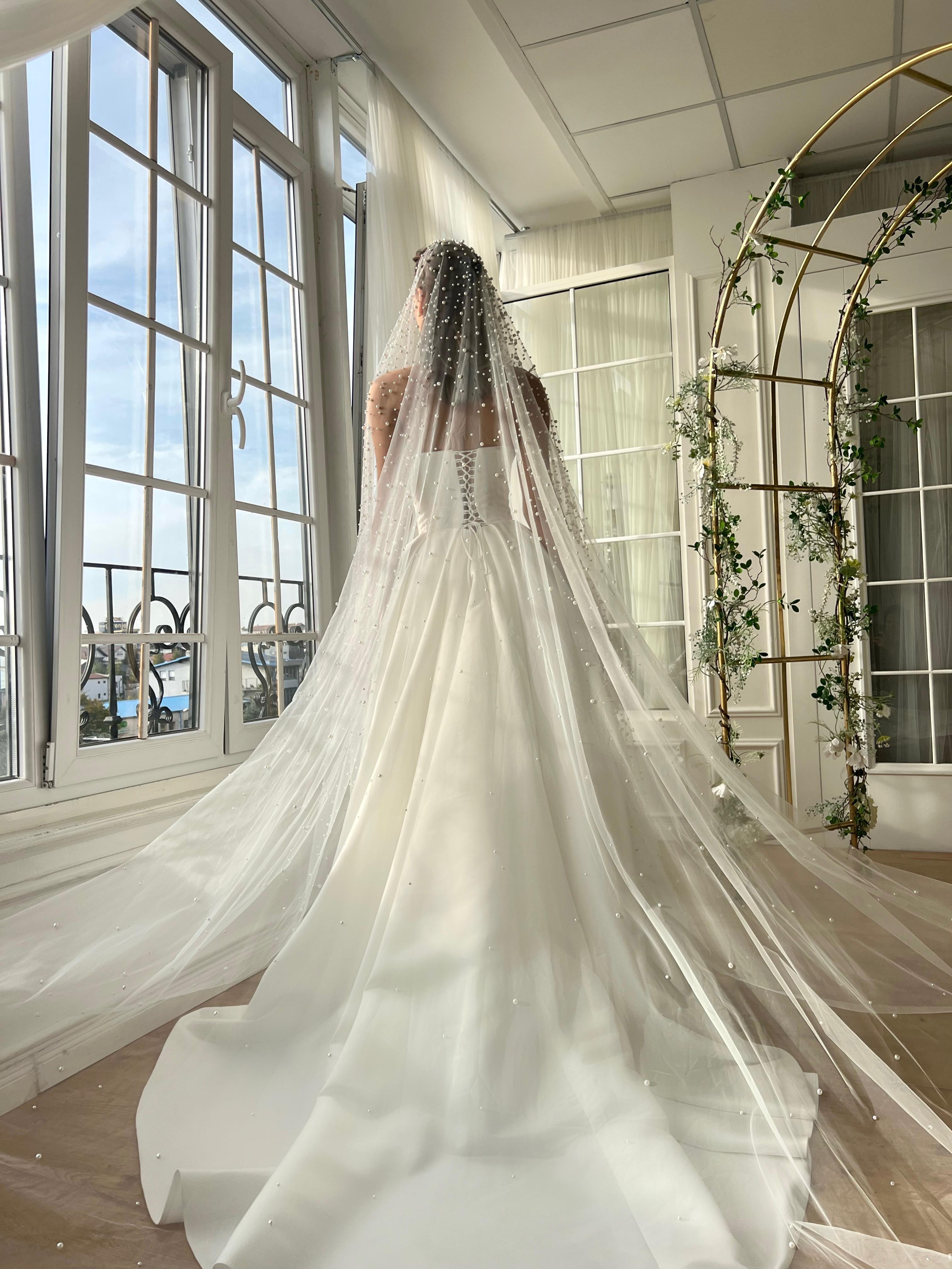 White bridal A-Line gown with beaded cape and no sleeves