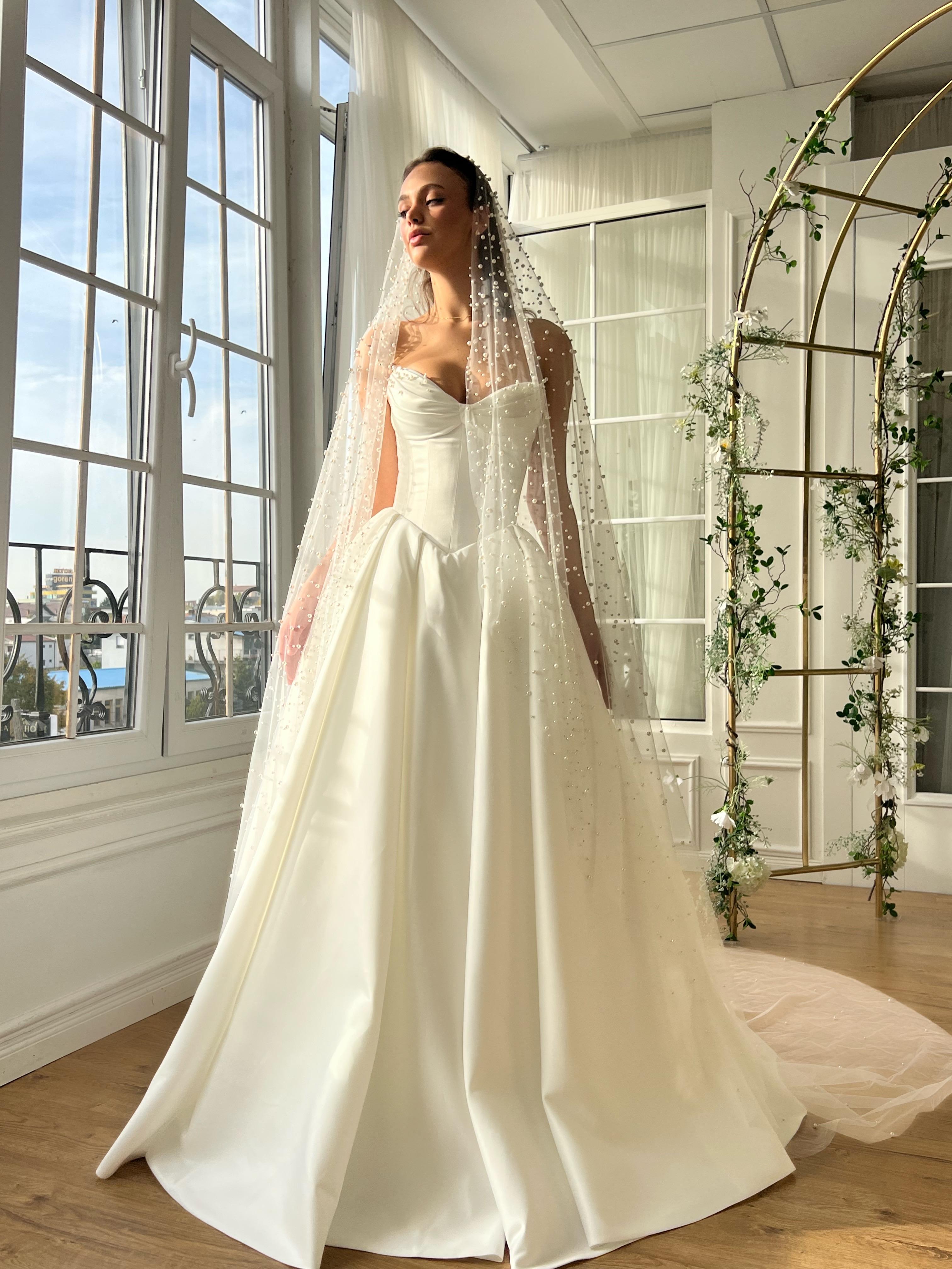 White bridal A-Line gown with beaded cape and no sleeves