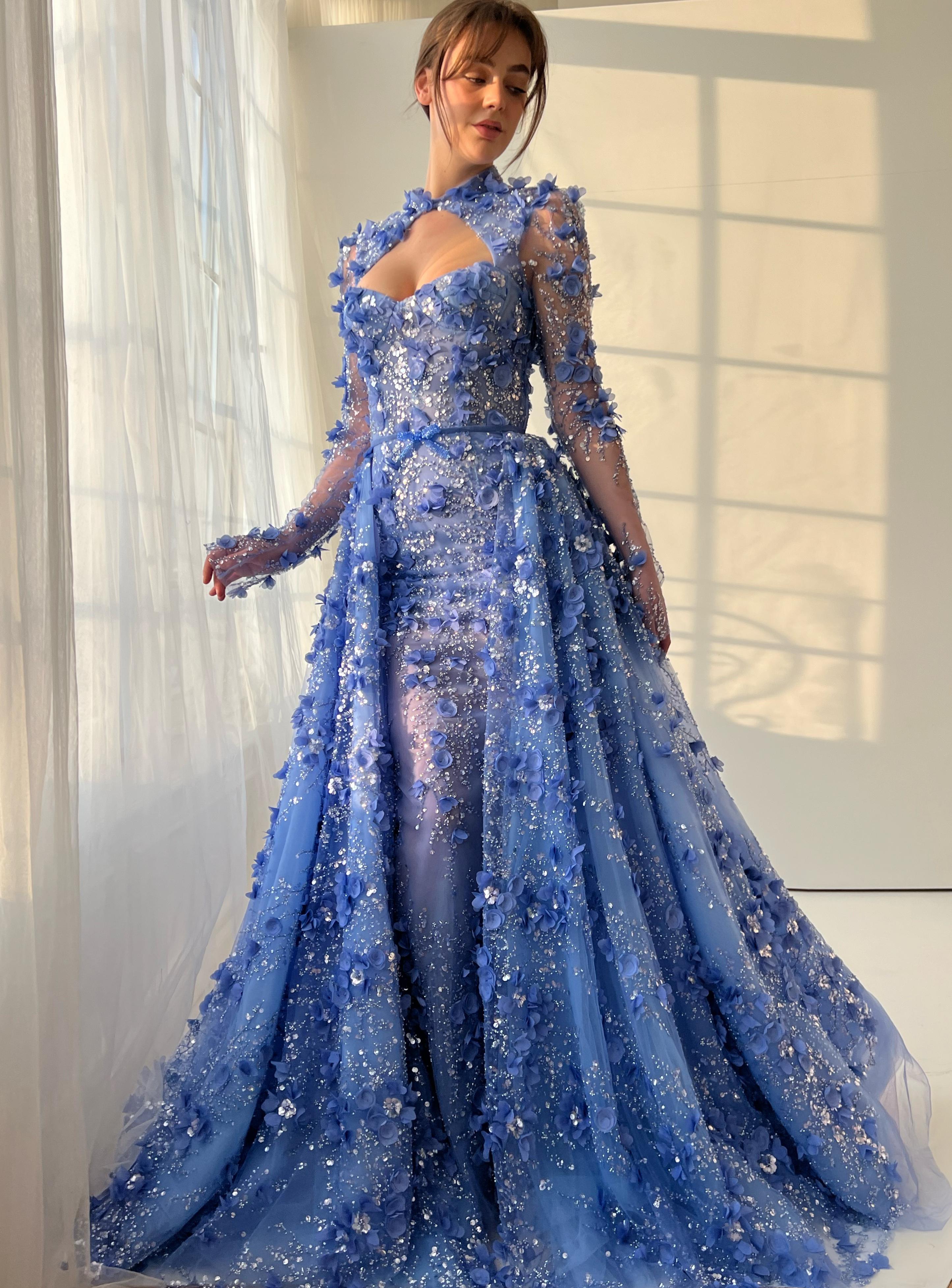 Blue A-Line gown with overskirt, long sleeves and embroidery