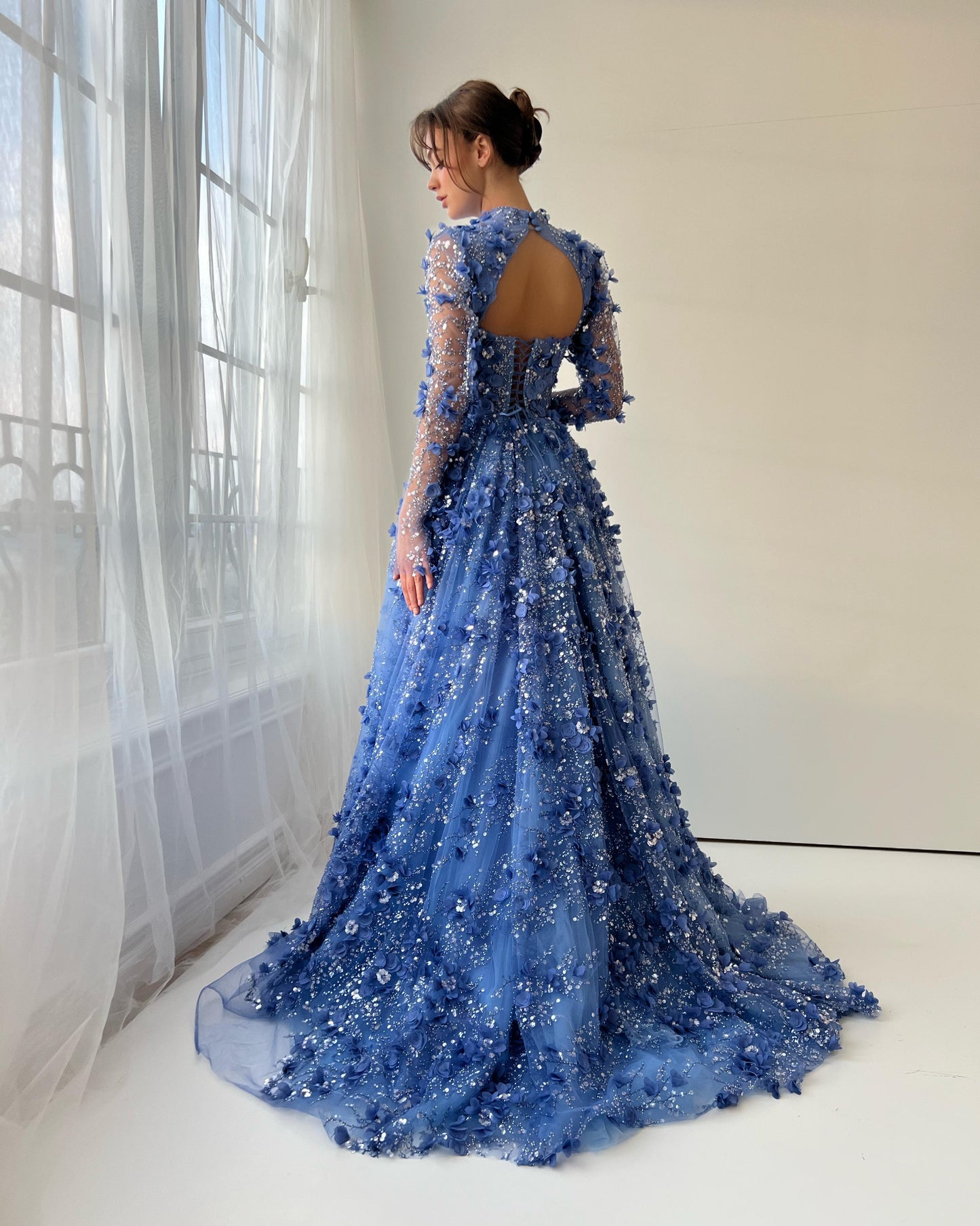 Blue A-Line gown with overskirt, long sleeves and embroidery