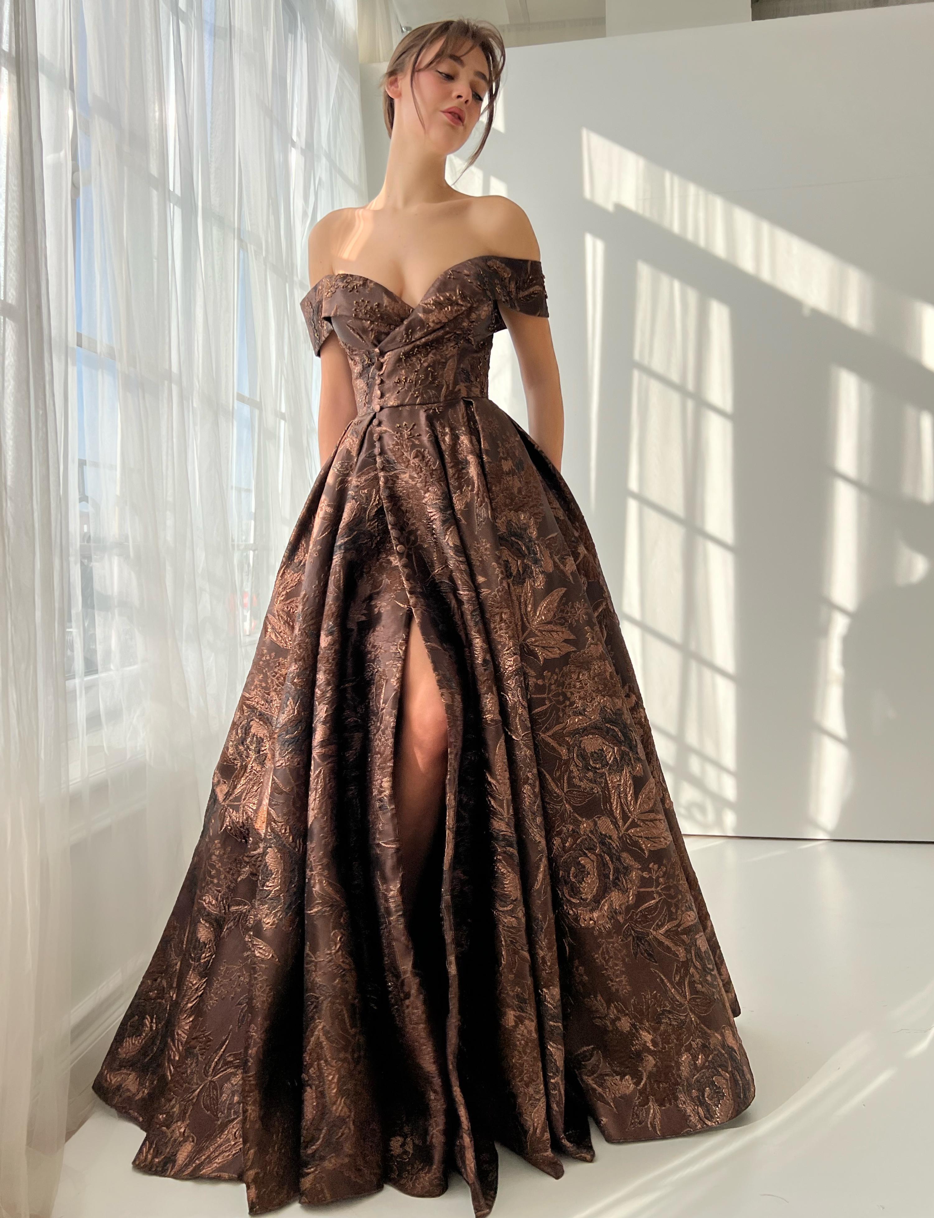 Brown A-line dress with off the shoulder sleeves and brocade fabric