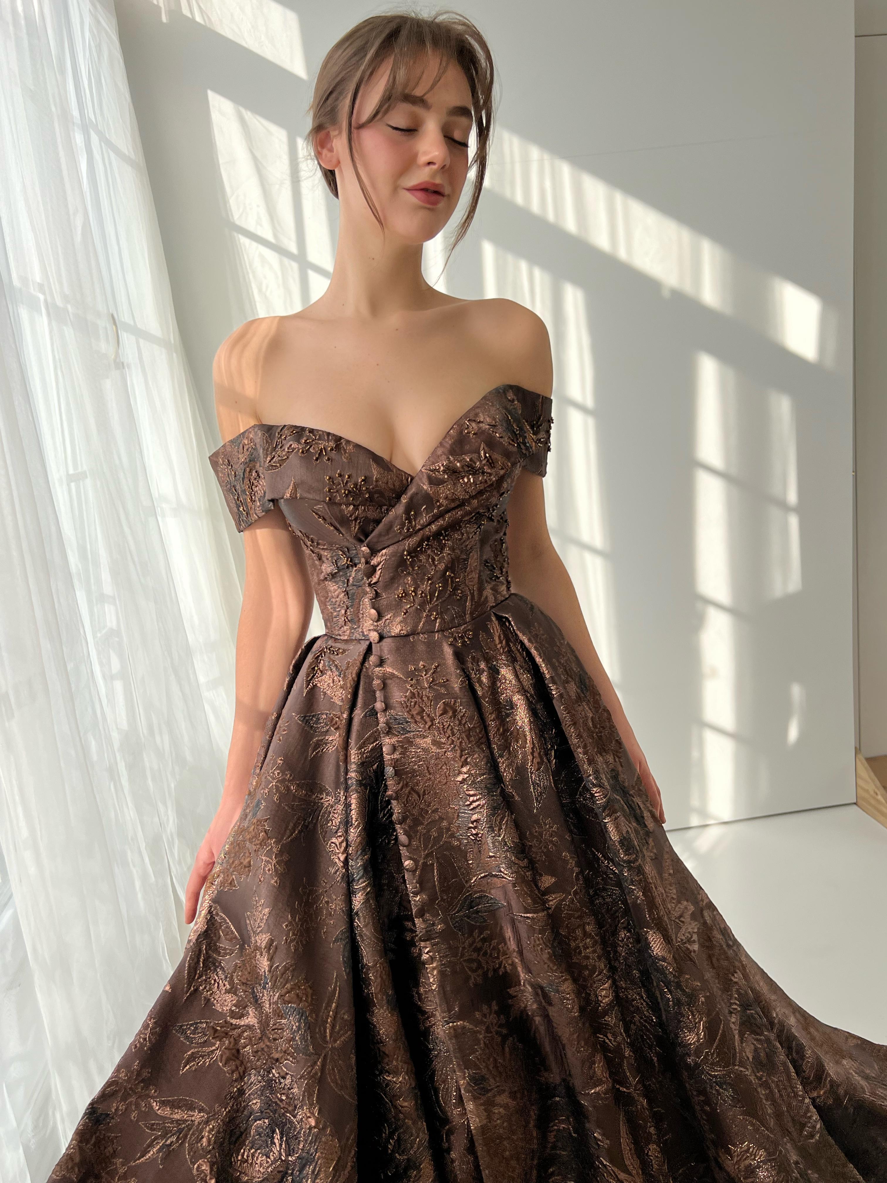 Brown A-line dress with off the shoulder sleeves and brocade fabric