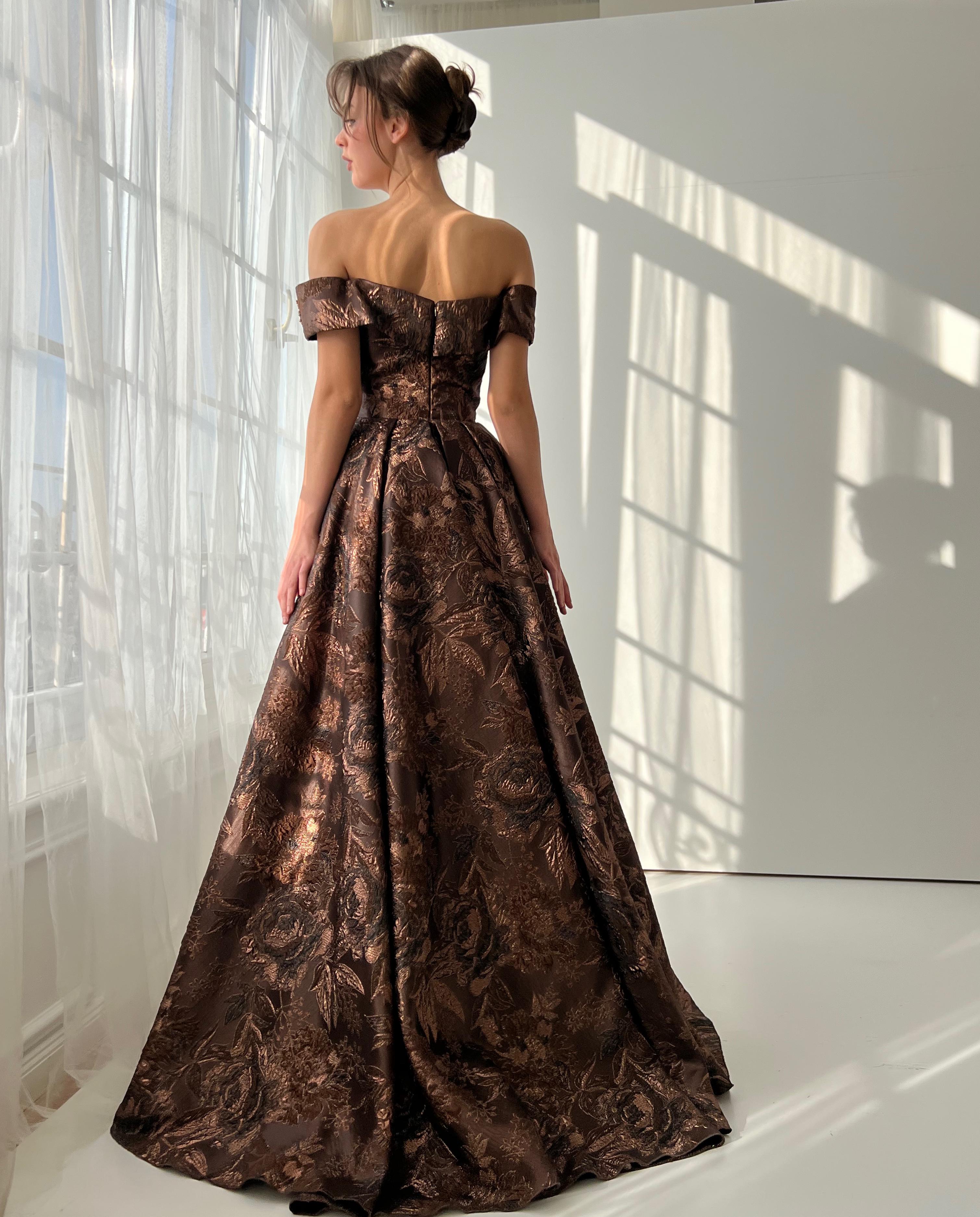 Brown A-line dress with off the shoulder sleeves and brocade fabric