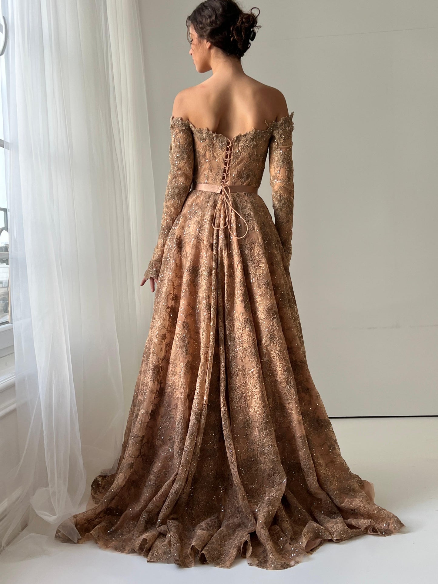 Brown A-Line gown with long off the shoulder sleeves and embroidery