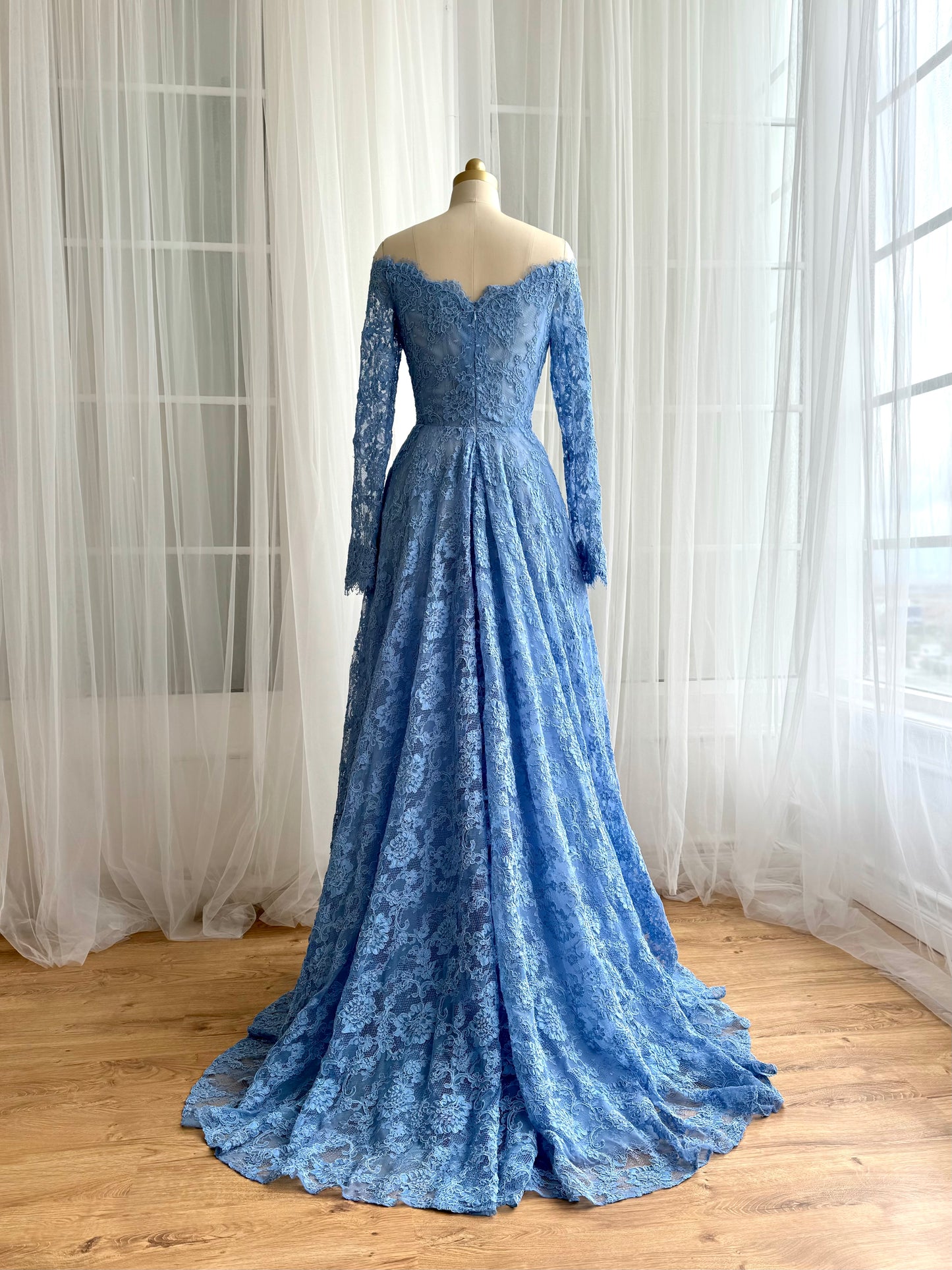 Blue A-Line gown with long off the shoulder sleeves and lace