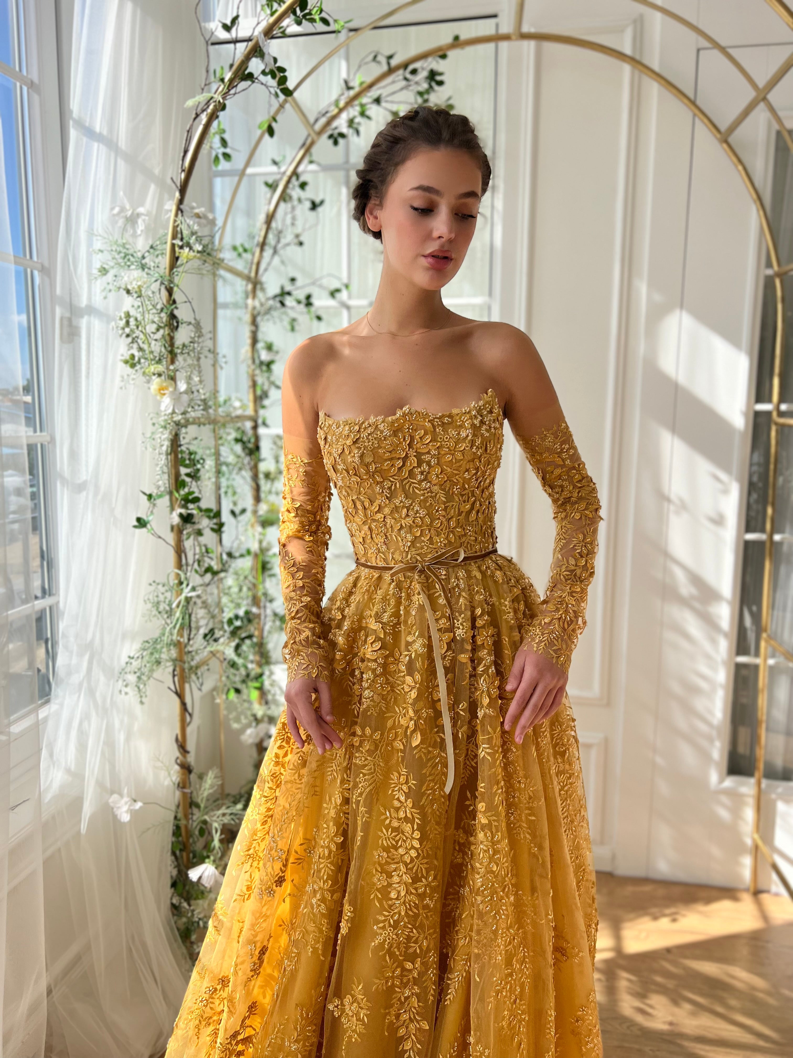 Gold A-Line dress with long off the shoulder sleeves and embroidery