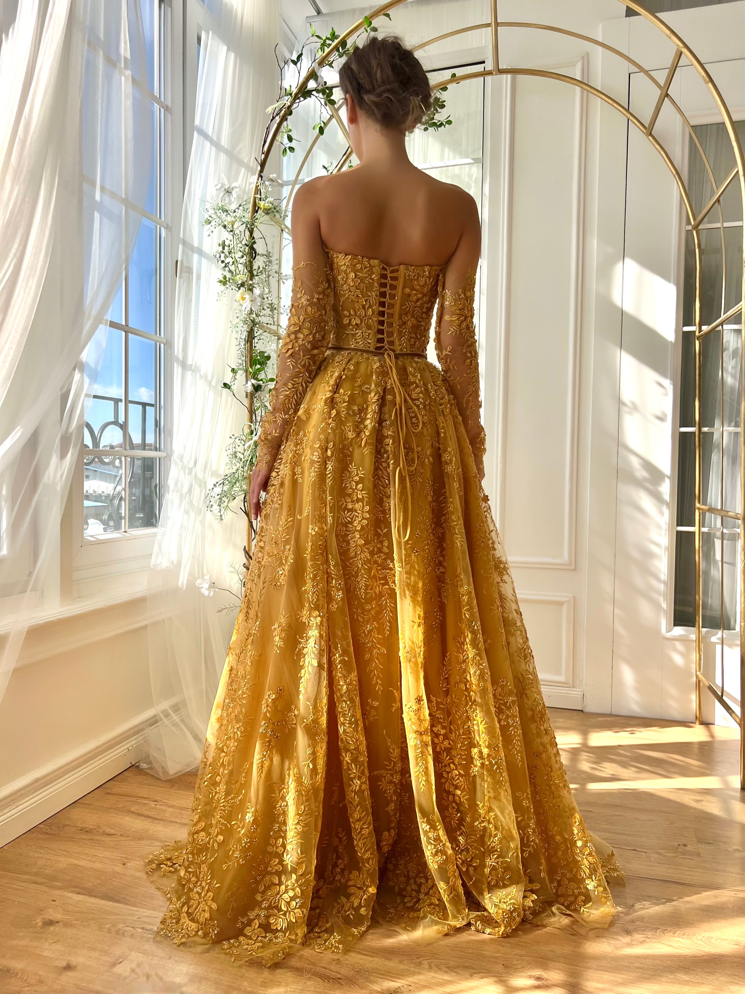 Gold A-Line dress with long off the shoulder sleeves and embroidery