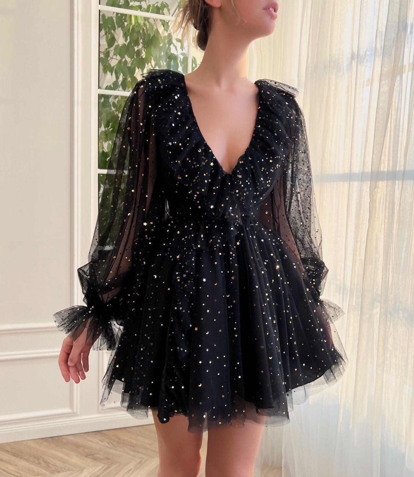 Black mini dress with long sleeves and starry fabric