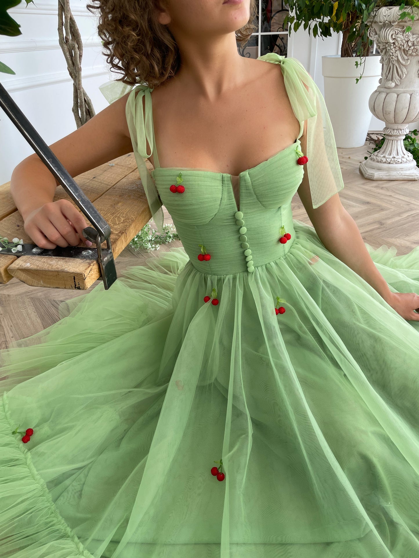 Green midi dress with bow straps and embroidered cherries